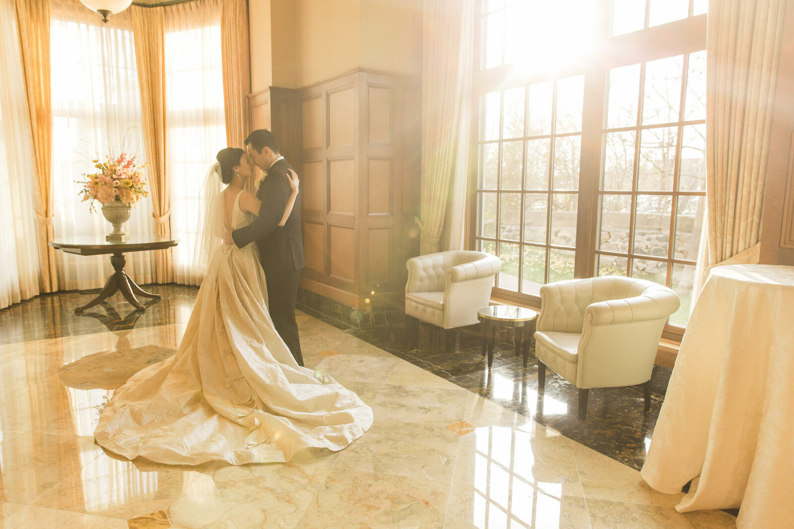 bride and groom in elegant hall with crazy sun flare