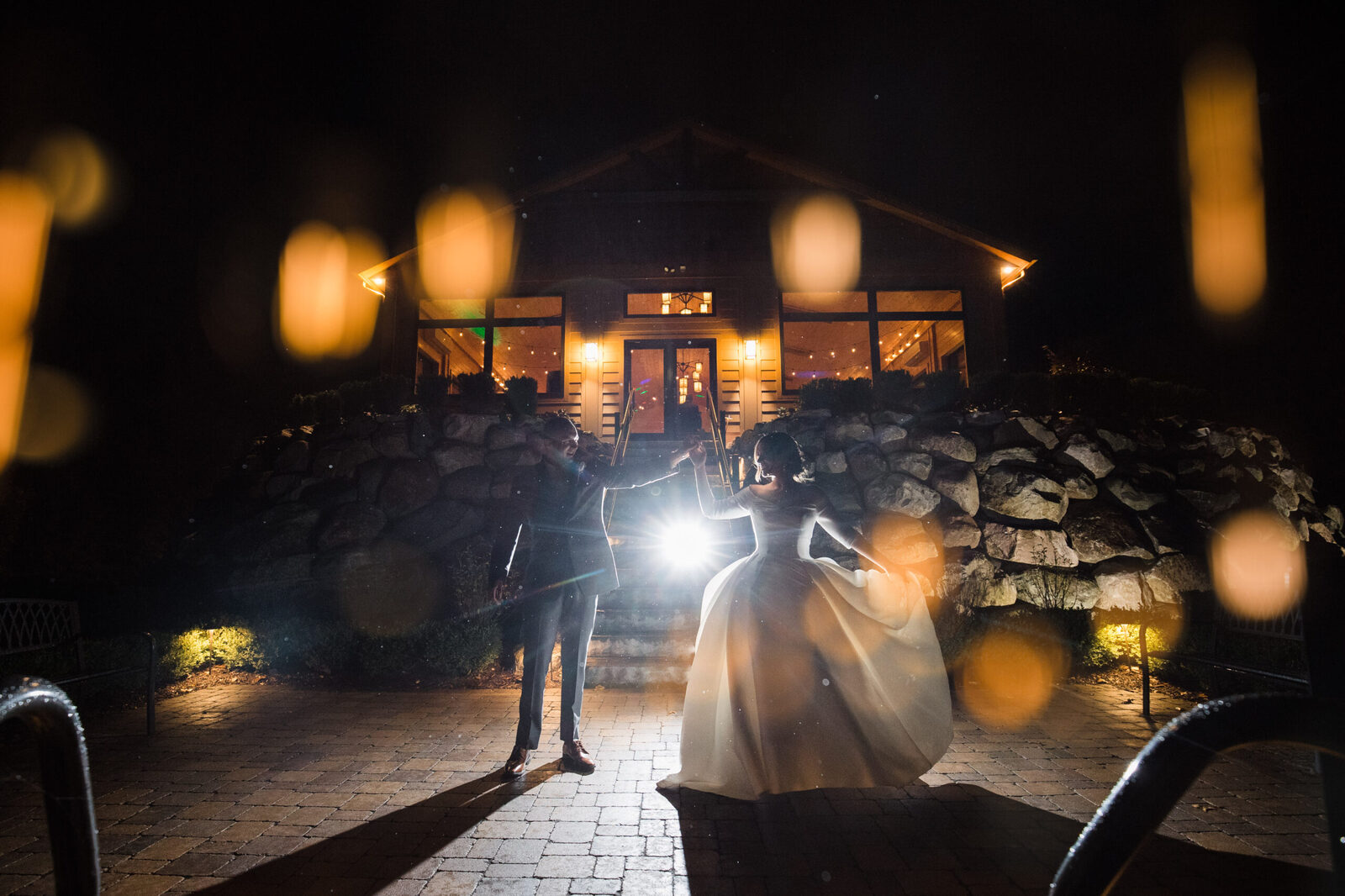 couple dancing at night in front of wedding venue